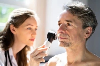 Dermatologist examining a patient