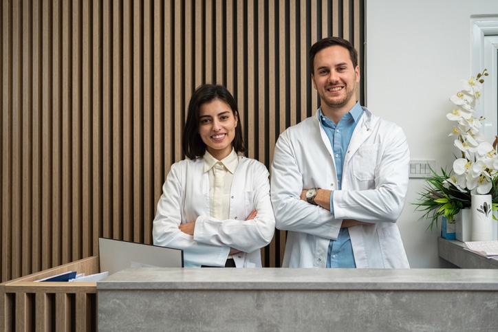 Portrait of Caucasian female and male doctors at the medical clinic reception